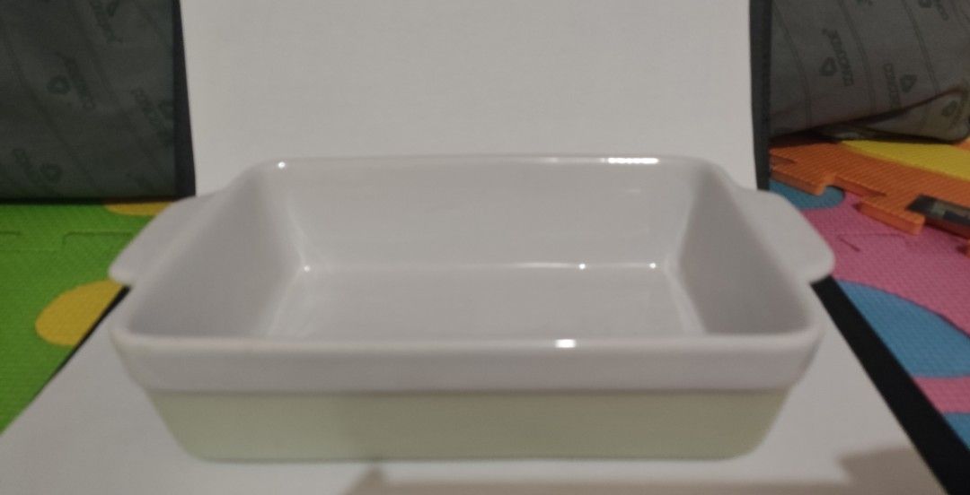Ceramic Baking Dish with Handles (Category: Bakeware) located in Makati City. Submitted by roamcarlos (Listing ID 1434080430, Image 2). Description: - Rectangular ceramic baking dish - Features convenient handles - Two-tone design: light green exterior, white interior and rim - Clean and ready for use - Ideal for baking casseroles, desserts, and more.