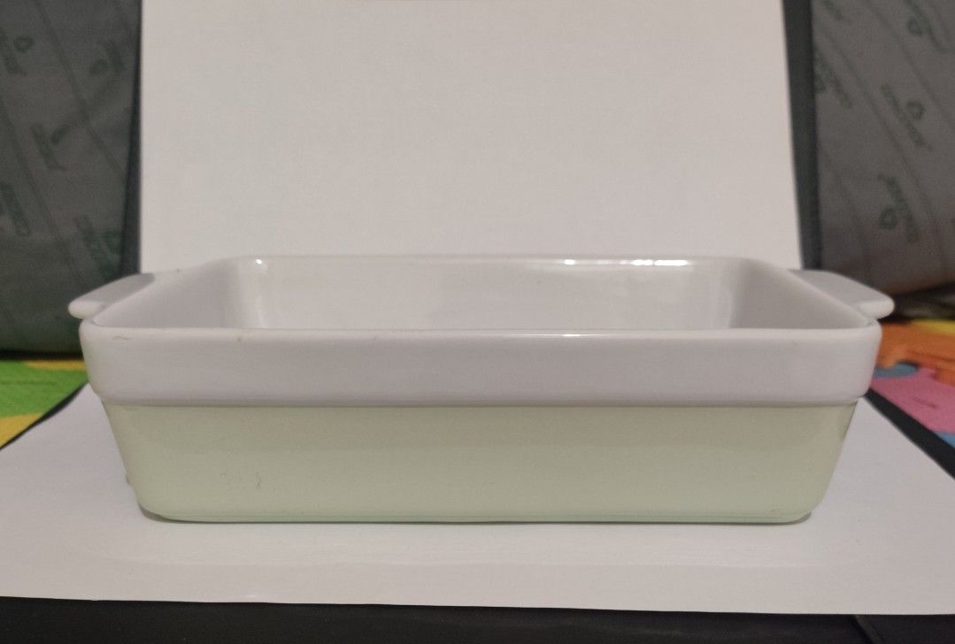 Ceramic Baking Dish with Handles (Category: Bakeware) located in Makati City. Submitted by roamcarlos (Listing ID 1434080430, Image 1). Description: - Rectangular ceramic baking dish - Features convenient handles - Two-tone design: light green exterior, white interior and rim - Clean and ready for use - Ideal for baking casseroles, desserts, and more.