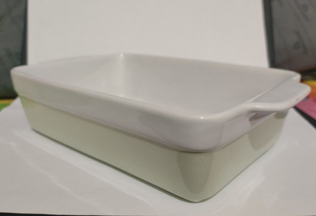 Ceramic Baking Dish with Handles (Category: Bakeware) located in Makati City. Submitted by roamcarlos (Listing ID 1434080430, Image 3). Description: - Rectangular ceramic baking dish - Features convenient handles - Two-tone design: light green exterior, white interior and rim - Clean and ready for use - Ideal for baking casseroles, desserts, and more.