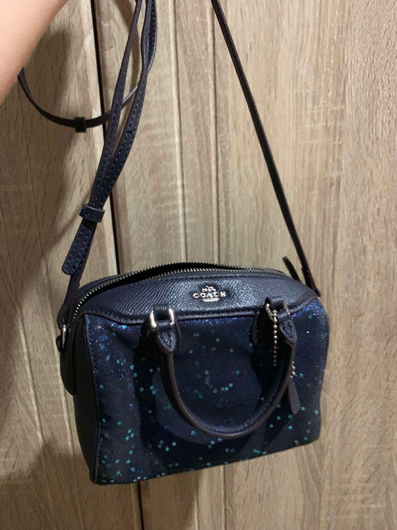 Coach Micro Bennett Satchel with Star Glitter (Category: Luxury Bags & Wallets) located in Talavera. Submitted by charmaine.delima (Listing ID 1434039453, Image 1). Description: - Coach Micro Bennett Satchel - Unique star glitter design - Dark blue color - Top handle and sling - Zip closure - Small Coach logo - Compact size, perfect for essentials.