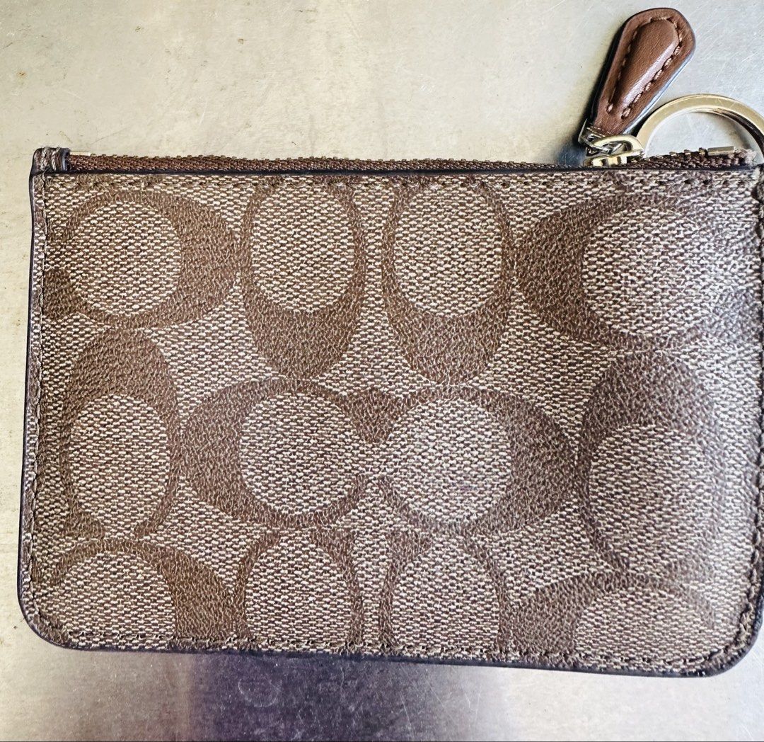 Coach Signature Zip Card Case (Category: Luxury Bags & Wallets) located in Paranaque City. Submitted by wisemomatwork (Listing ID 1433994553, Image 2). Description: - Authentic Coach card case - Signature print design - Secure zip closure - Includes a key ring - Features the Coach logo - Elegant gold-toned zipper - Stylish brown and tan color - Lightly used - payment Gcash, BPI or BDO - delivery fee for buyer’s account.