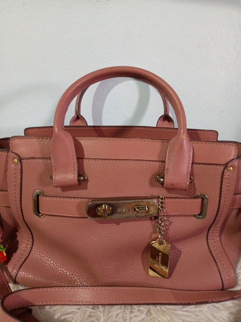 Coach Swagger 27 2 way preloved Japan (Category: Luxury Bags & Wallets) located in Gapan. Submitted by cristina_adofina (Listing ID 1434047109, Image 1). Description: - Authentic Coach Swagger 27 handbag - Color: Dusty Rose - Features a top handle and detachable shoulder strap - Gold-tone hardware - Zipper closure - Interior includes Coach label and model number34816 searchable code .thank you.