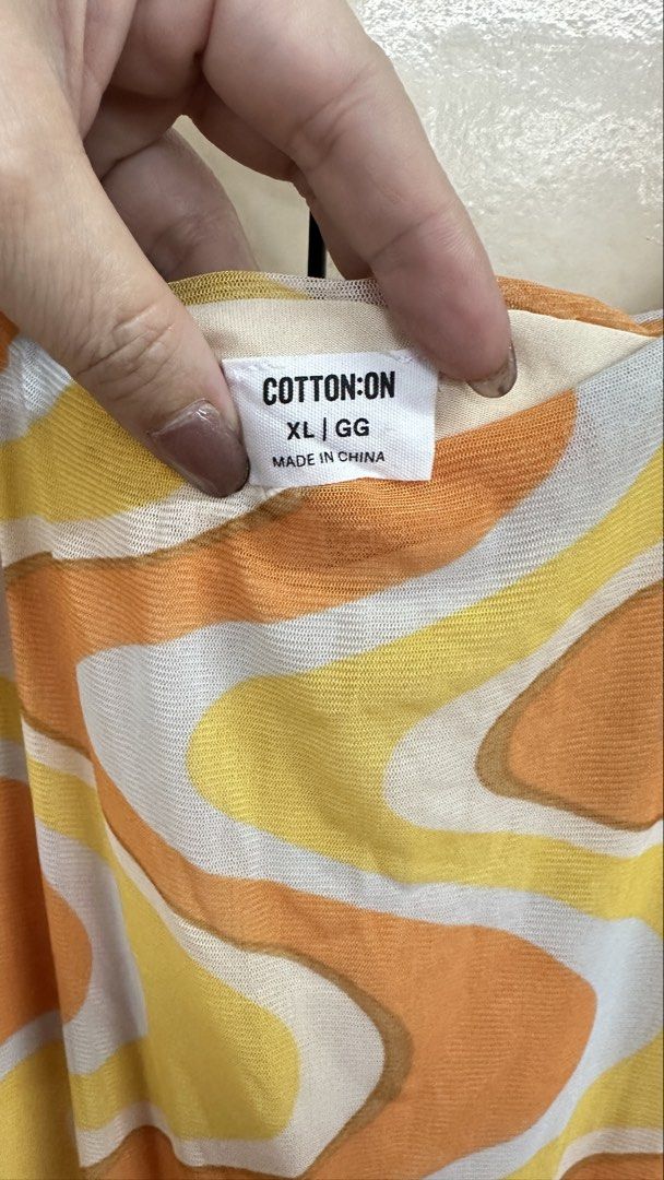 Cotton On XL Dress (Category: Dresses) located in Malabon City. Submitted by xeniag (Listing ID 1434072418, Image 2). Description: - Cotton On dress - Size: XL - Pattern: Wavy (orange, yellow, white) - Neckline: Scoop - Length: Midi - Made in China.