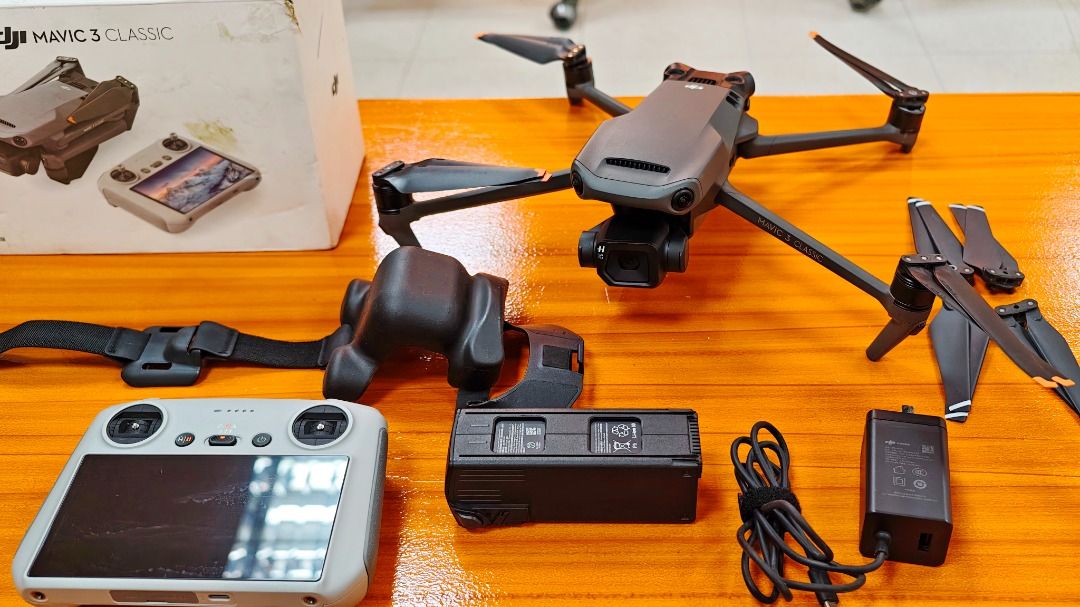 DJI Mavic 3 Classic Drone (Category: Drones) located in Mandaluyong City. Submitted by jrd_19 (Listing ID 1434032746, Image 2). Description: - DJI Mavic 3 Classic drone - Hasselblad 4/3 CMOS, 20 MP - Issue: Binded account, does not affect the drone's performance. - Includes remote controller with built-in screen(RC1) - Comes with battery, charger, and extra propellers - DJI Carrying bag and original box included - Color: Gray and black .