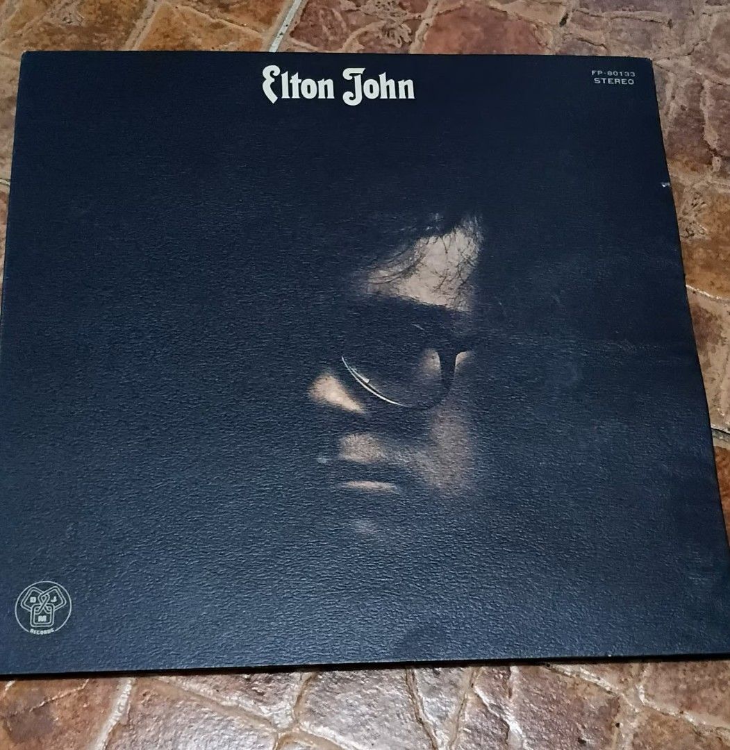 Elton John Vinyl Record (Category: Vinyls) located in Quezon City. Submitted by dancatz (Listing ID 1434089365, Image 1). Description: □ P750.00 □ vinyl record : mint condition □ cover jacket : partly warp □ Japan press - Elton John vinyl record - Features artist name on top - Includes a portrait of Elton John on the cover - Record label logo visible - Stereo recording LFB Seller location : Brgy. Sta. Teresita, Quezon City Please DM for more deta