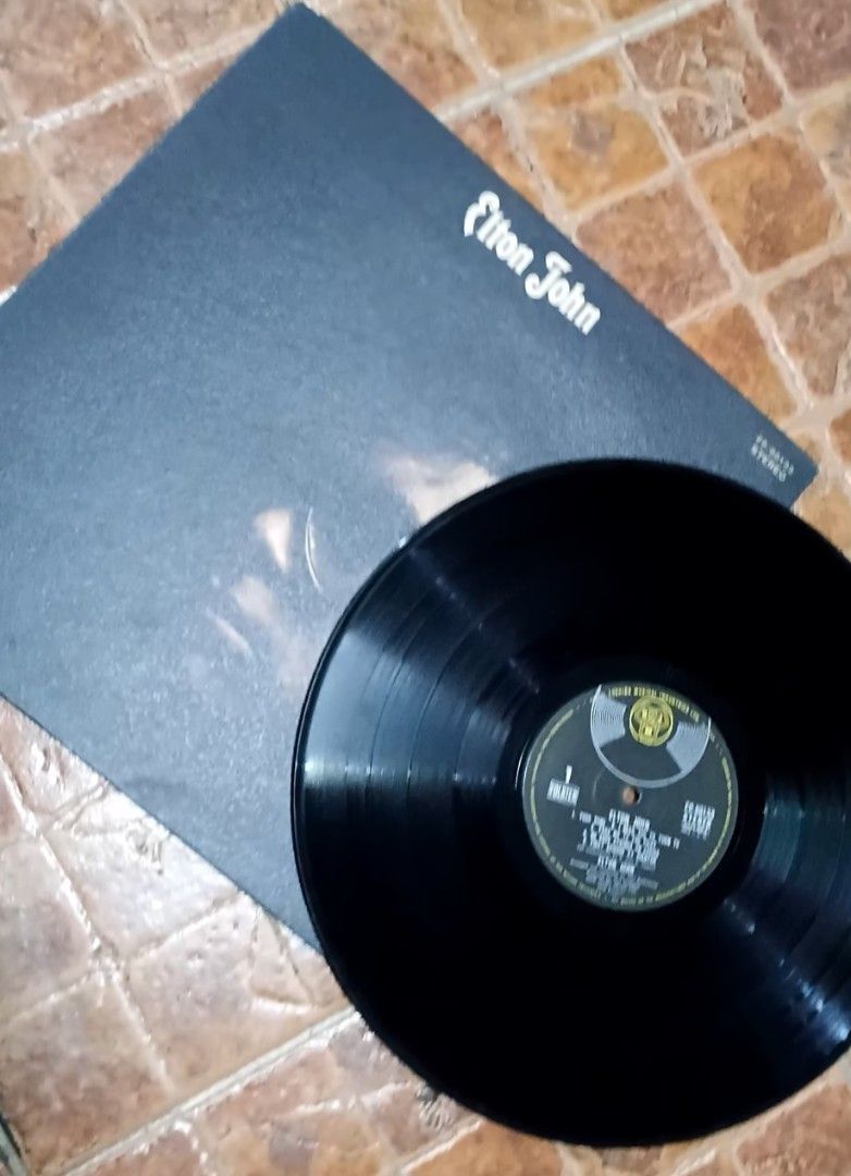 Elton John Vinyl Record (Category: Vinyls) located in Quezon City. Submitted by dancatz (Listing ID 1434089365, Image 2). Description: □ P750.00 □ vinyl record : mint condition □ cover jacket : partly warp □ Japan press - Elton John vinyl record - Features artist name on top - Includes a portrait of Elton John on the cover - Record label logo visible - Stereo recording LFB Seller location : Brgy. Sta. Teresita, Quezon City Please DM for more deta