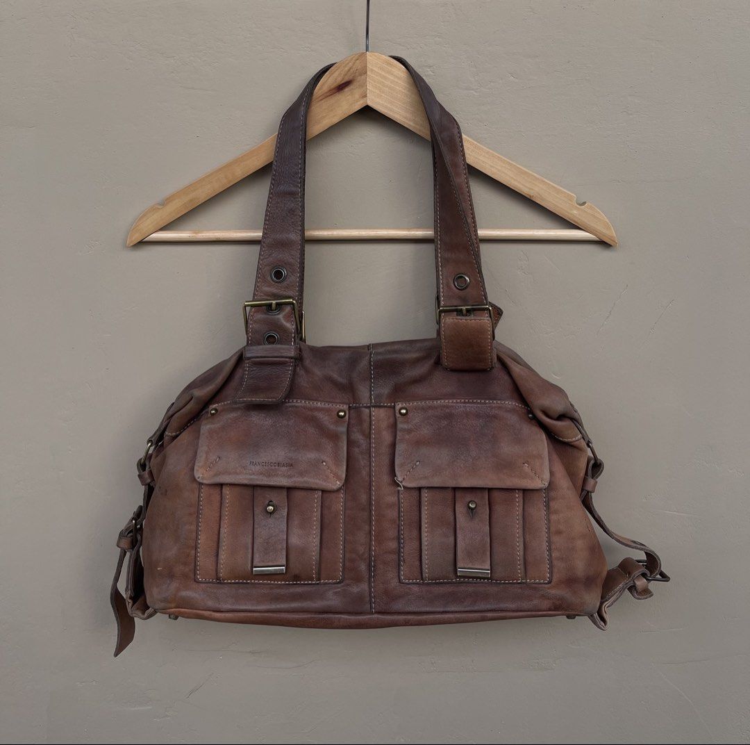 Fr*nces*o B*as*a Leather Handbag (Category: Luxury Bags & Wallets) located in Cagayan de Oro. Submitted by martinduarte22 (Listing ID 1433984795, Image 1). Description: - Francesco Biasia brown leather handbag - Two front pockets with flap closures - Buckle details on straps - Top handle design - Distressed leather - Spacious main compartment - Suitable for everyday use.