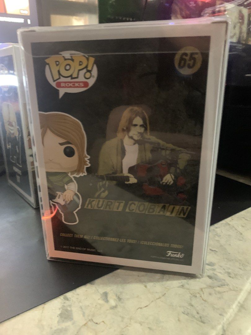 Funko Pop! Rocks Kurt Cobain #65 (Category: Designer & Blind Box Toys) located in Manila. Submitted by robertzombie (Listing ID 1434029364, Image 3). Description: - Funko Pop! Rocks figure of Kurt Cobain. - Number 65 in the Pop! Rocks series. - Depicts Kurt Cobain with a guitar. - Brand new in original packaging. - Box shows figure from multiple angles. 09153896941 e4.
