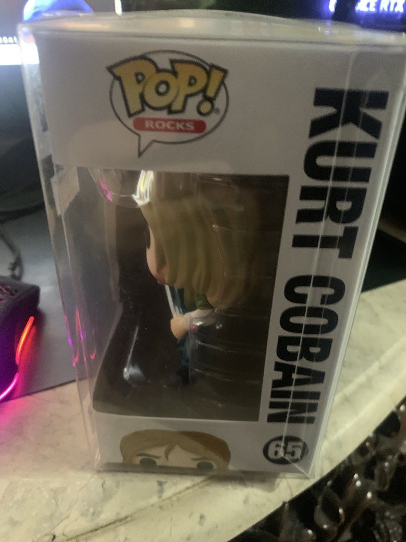 Funko Pop! Rocks Kurt Cobain #65 (Category: Designer & Blind Box Toys) located in Manila. Submitted by robertzombie (Listing ID 1434029364, Image 2). Description: - Funko Pop! Rocks figure of Kurt Cobain. - Number 65 in the Pop! Rocks series. - Depicts Kurt Cobain with a guitar. - Brand new in original packaging. - Box shows figure from multiple angles. 09153896941 e4.