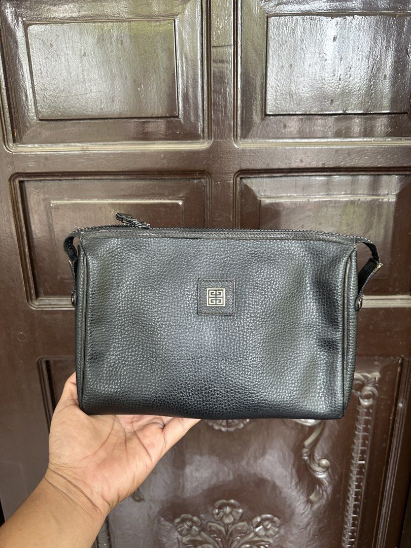 Givenchy Black Leather Clutch (Category: Luxury Bags & Wallets) located in Bustos. Submitted by theprelovedshopbulacan (Listing ID 1433996722, Image 1). Description: - Authentic Fendi clutch - Black leather - Zip closure - Rectangular shape - Interior lined - "Made in Italy" stamp - Fendi logo on exterior - Minor wear and tear inside.