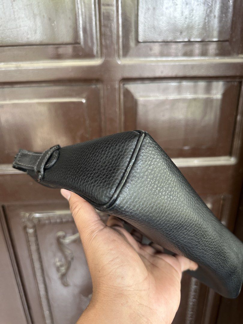 Givenchy Black Leather Clutch (Category: Luxury Bags & Wallets) located in Bustos. Submitted by theprelovedshopbulacan (Listing ID 1433996722, Image 3). Description: - Authentic Fendi clutch - Black leather - Zip closure - Rectangular shape - Interior lined - "Made in Italy" stamp - Fendi logo on exterior - Minor wear and tear inside.