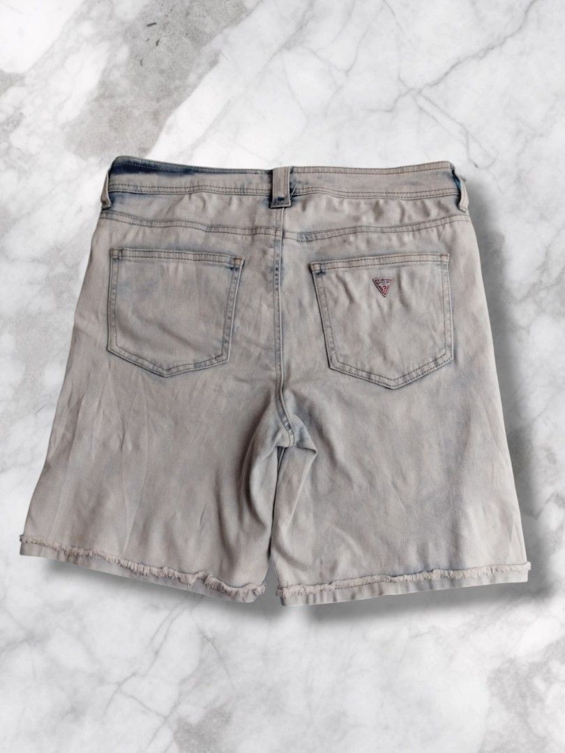 Guess Cut-off Denim Bermuda Shorts (Category: Shorts) located in Baguio. Submitted by nifty.grails (Listing ID 1434061855, Image 2). Description: W: 30 | L: 17 - Guess light acid wash denim shorts - Button closure with Guess Jeans logo - Two front and two back pockets - Guess logo on back pocket - Frayed hem - Made in China.
