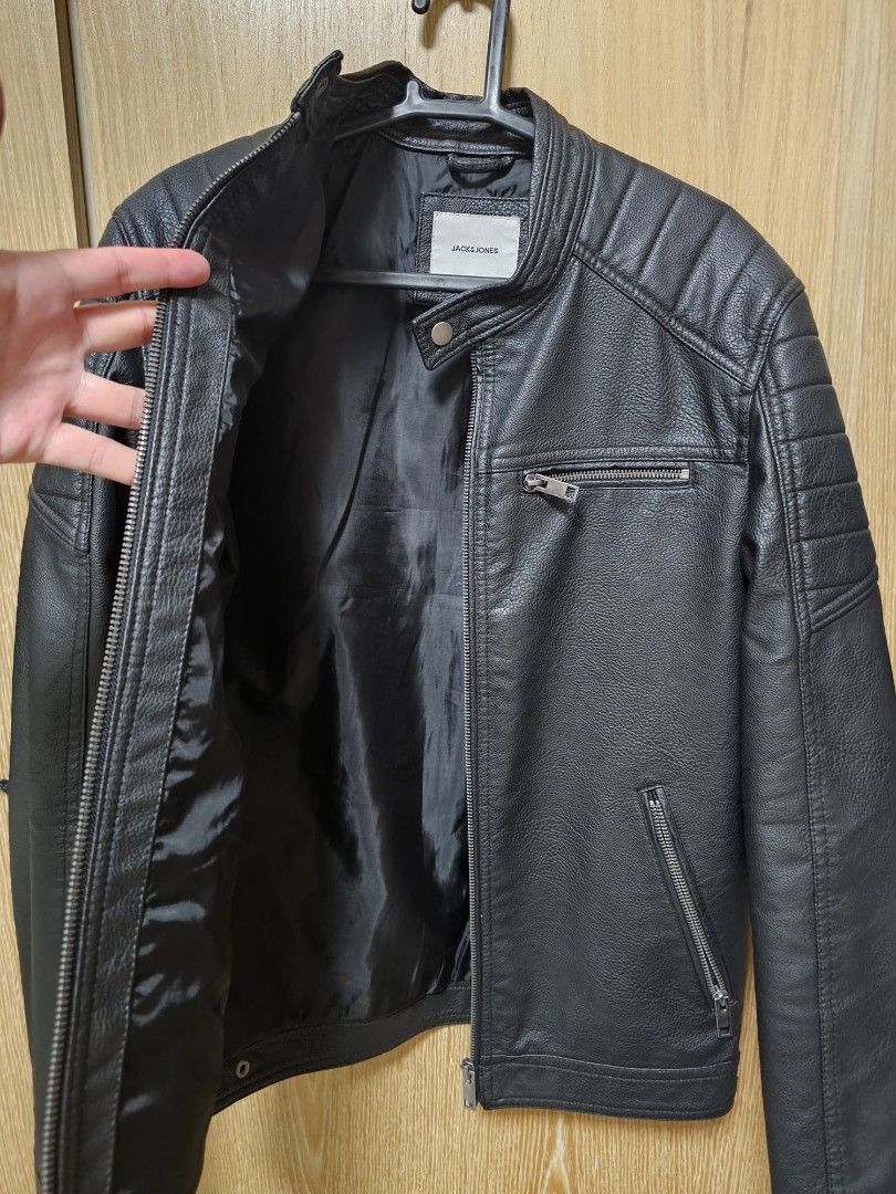 Jack & Jones Black Faux Leather Jacket (Category: Coats, Jackets and Outerwear) located in Manila. Submitted by urbanashes-collector (Listing ID 1434122979, Image 3). Description: - Jack & Jones faux leather jacket - Color: Black - Features: - Zip closure - Multiple pockets - Stand-up collar - Quilted detailing on shoulders and sleeves - Shoulder width: Approximately 48cm - Perfect for a stylish, edgy look.
