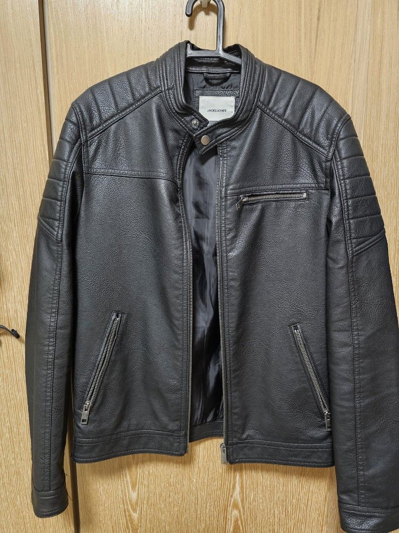 Jack & Jones Black Faux Leather Jacket (Category: Coats, Jackets and Outerwear) located in Manila. Submitted by urbanashes-collector (Listing ID 1434122979, Image 1). Description: - Jack & Jones faux leather jacket - Color: Black - Features: - Zip closure - Multiple pockets - Stand-up collar - Quilted detailing on shoulders and sleeves - Shoulder width: Approximately 48cm - Perfect for a stylish, edgy look.