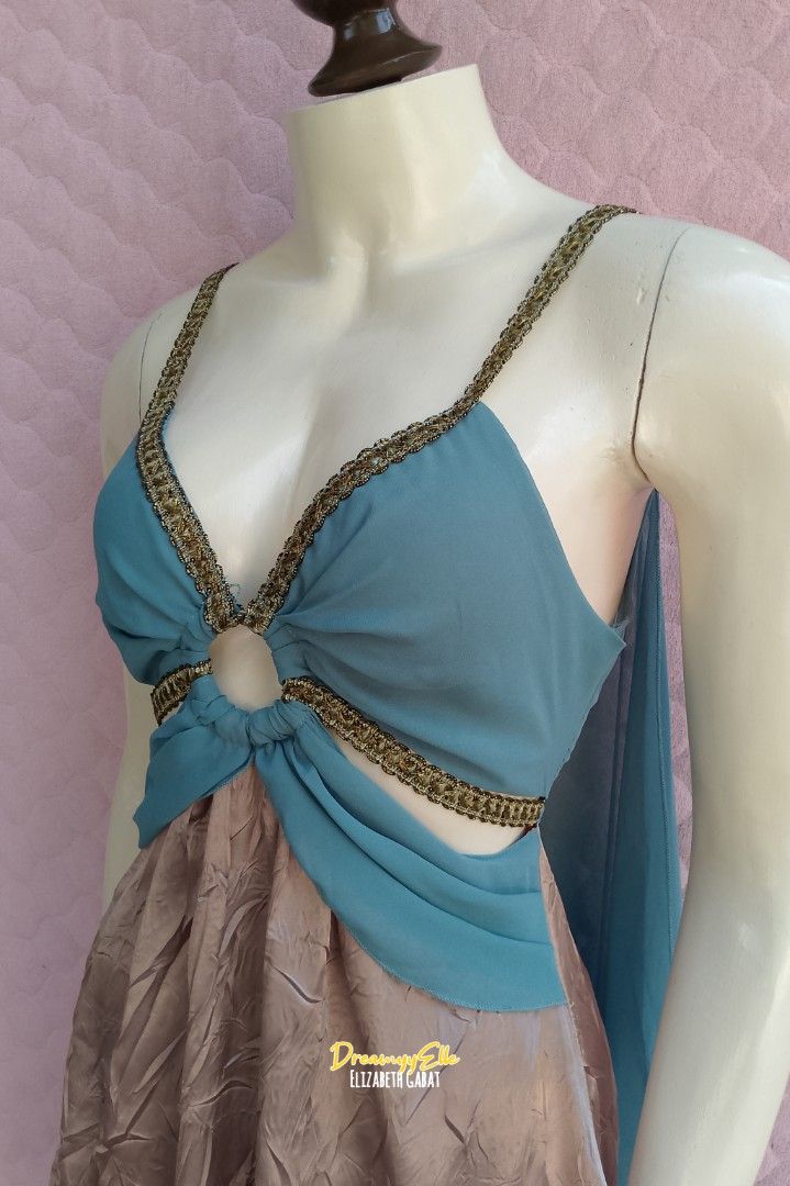 Leg Avenue Ethereal Boho Cut-Out Mini Dress (Category: Dresses) located in Bayambang. Submitted by dreamyy_elizabeth (Listing ID 1434002159, Image 2). Description: Designed with an ethereal, bohemian flair, this dress combines a dreamy teal chiffon-style bodice with a high-shine, iridescent mauve crinkle skirt. Whether you’re heading to a music festival, a summer garden party, or looking for the perfect "Fairy-core" aesthetic, this piece delivers