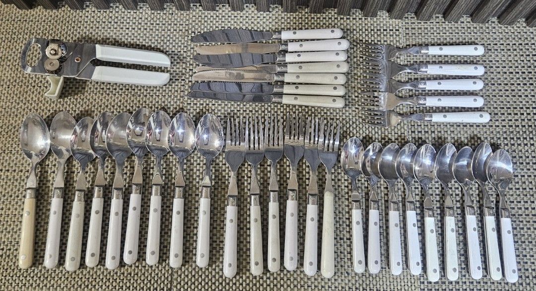 Lifetime Stainless Korea Cutlery Set 37 pcs. (Category: Dinnerware & Cutlery) located in Rizal. Submitted by cherry_garcia (Listing ID 1434055801, Image 1). Description: - Complete cutlery set from Lifetime Stainless Korea. - Includes spoons, forks, knives, and a can opener. - Features white handles with a riveted design. - Made of stainless steel. - Knives have serrated edges. - Brand name visible on cutlery..