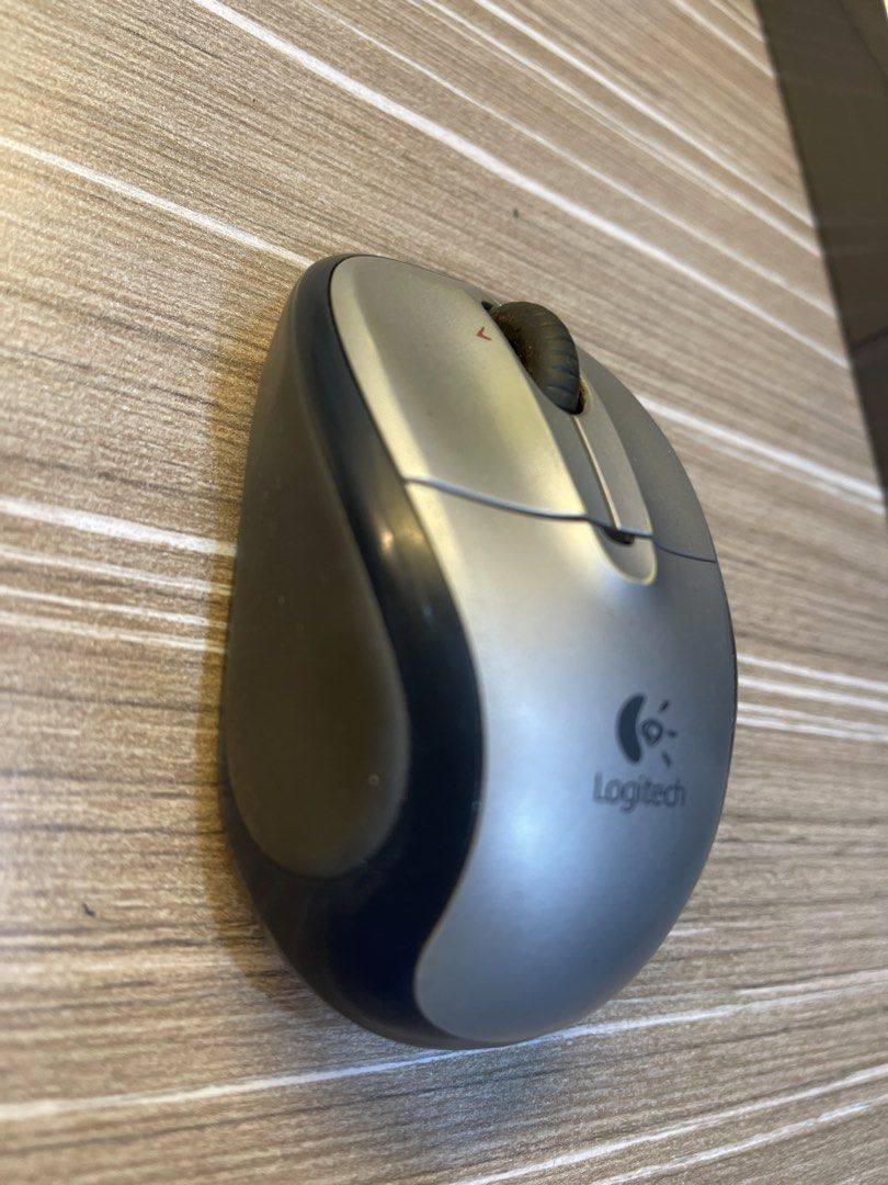 Logitech Wireless Mouse (Category: Mouse & Mousepads) located in Shah Alam. Submitted by quickcat_490823 (Listing ID 1433991908, Image 1). Description: - Logitech wireless mouse - Color: Silver and black - Features a scroll wheel - Logitech logo visible - In good working condition.