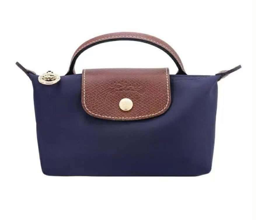Longchamp Le Pliage Cosmetic Bag (Category: Luxury Bags & Wallets) located in Caloocan City. Submitted by ericavi_g (Listing ID 1433986302, Image 2). Description: - Longchamp Le Pliage cosmetic bag - Available Colors: Grey, Navy Blue, Light Blue - Features: - Top handle - Flap closure with snap button - Zipper closure - Compact size, ideal for cosmetics and small essentials. free long strap.