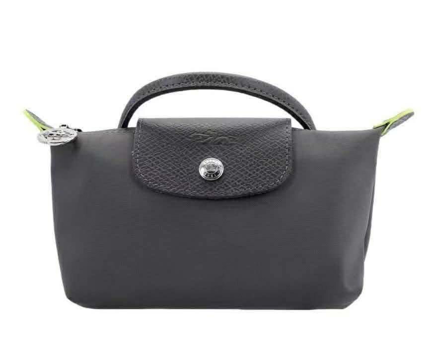 Longchamp Le Pliage Cosmetic Bag (Category: Luxury Bags & Wallets) located in Caloocan City. Submitted by ericavi_g (Listing ID 1433986302, Image 1). Description: - Longchamp Le Pliage cosmetic bag - Available Colors: Grey, Navy Blue, Light Blue - Features: - Top handle - Flap closure with snap button - Zipper closure - Compact size, ideal for cosmetics and small essentials. free long strap.