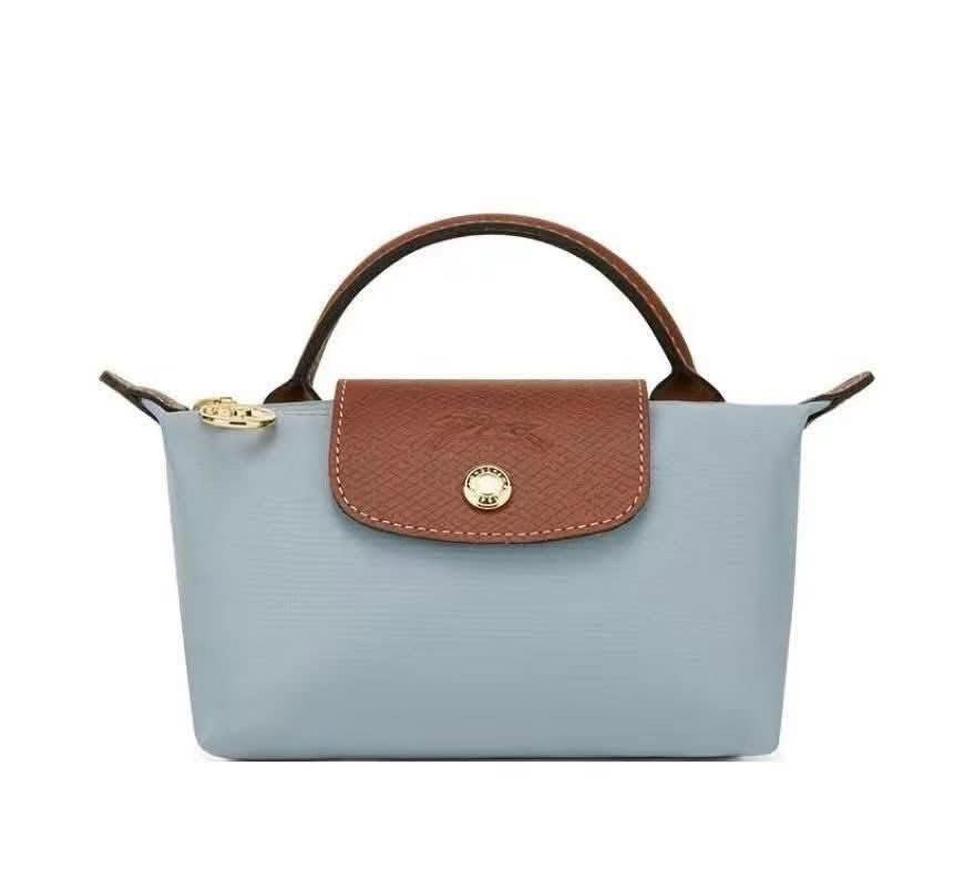 Longchamp Le Pliage Cosmetic Bag (Category: Luxury Bags & Wallets) located in Caloocan City. Submitted by ericavi_g (Listing ID 1433986302, Image 3). Description: - Longchamp Le Pliage cosmetic bag - Available Colors: Grey, Navy Blue, Light Blue - Features: - Top handle - Flap closure with snap button - Zipper closure - Compact size, ideal for cosmetics and small essentials. free long strap.