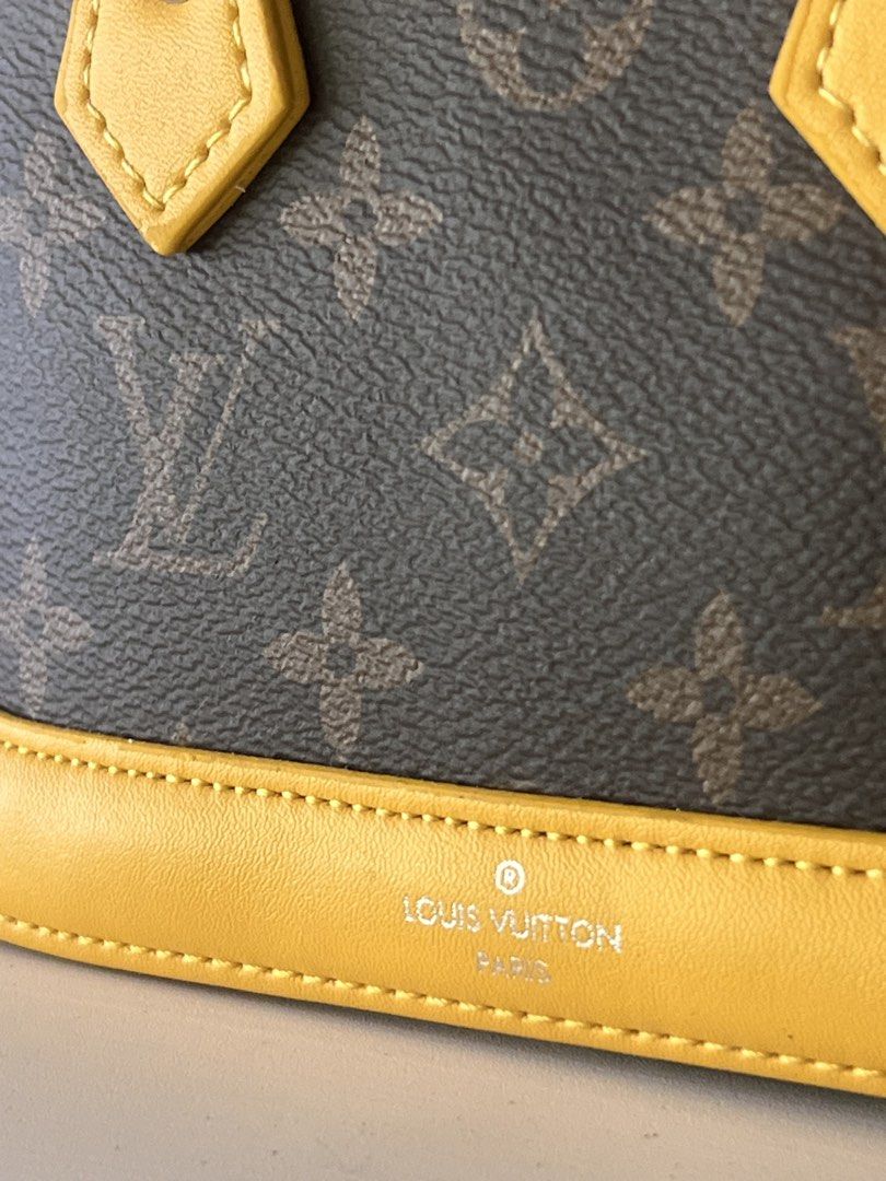 Louis Vuitton Alma BB Handbag (Category: Luxury Bags & Wallets) located in Dagupan City. Submitted by dela.sole (Listing ID 1433980846, Image 2). Description: - Authentic Louis Vuitton Alma BB - Iconic Monogram canvas - Vibrant yellow leather trim and handles - Secure zip closure - Elegant silver-tone hardware - Interior lined with yellow fabric - Includes Louis Vuitton label - 'Made in France' marking.