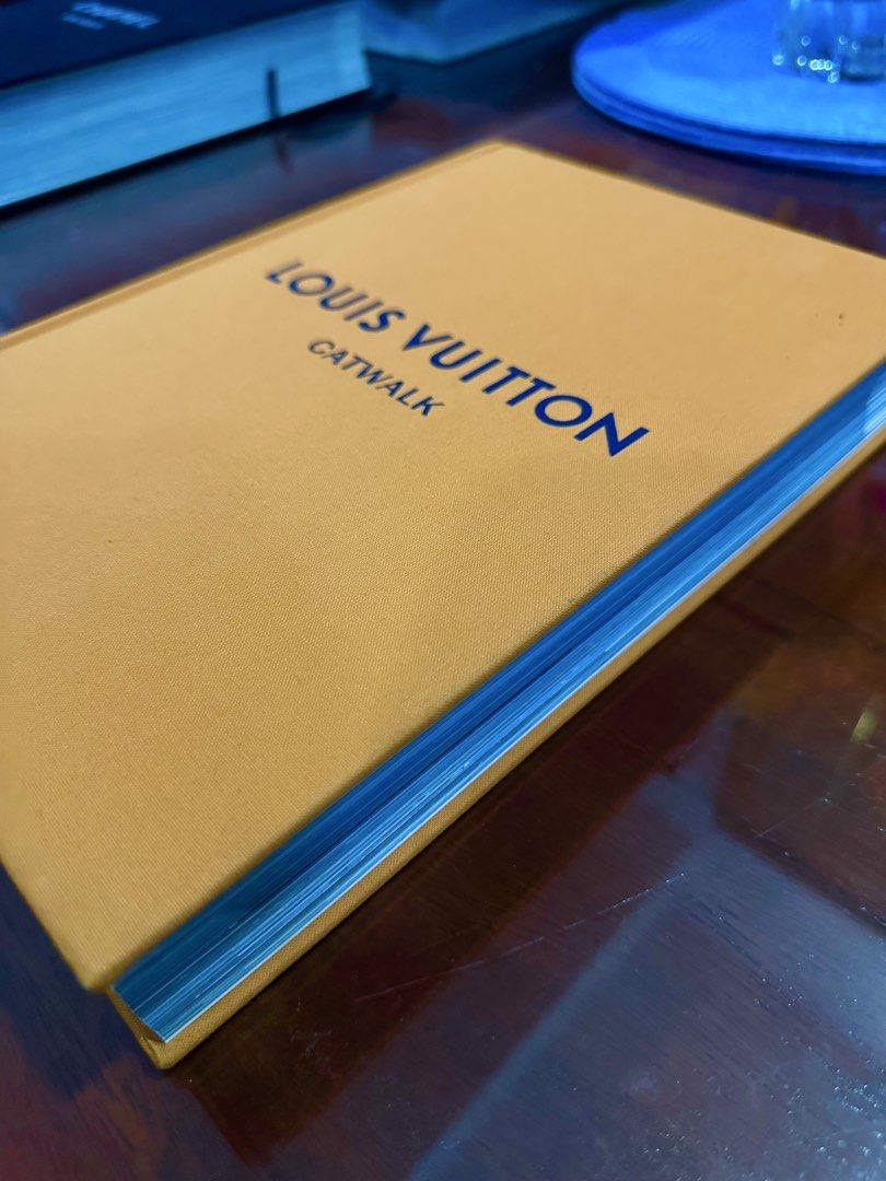 Louis Vuitton Catwalk Book (Category: Luxury Bags & Wallets) located in Subic. Submitted by luxxebrands4less (Listing ID 1434107955, Image 3). Description: -ON HAND - Louis Vuitton Catwalk book - Showcases fashion designs and runway looks - Mustard yellow cover - Blue text (brand name and title).