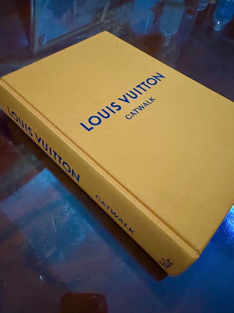 Louis Vuitton Catwalk Book (Category: Luxury Bags & Wallets) located in Subic. Submitted by luxxebrands4less (Listing ID 1434107955, Image 2). Description: -ON HAND - Louis Vuitton Catwalk book - Showcases fashion designs and runway looks - Mustard yellow cover - Blue text (brand name and title).