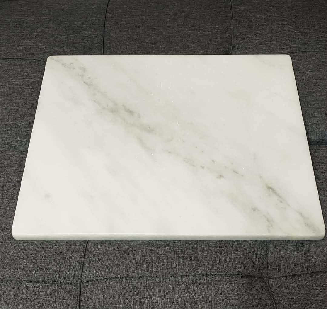 Marble Pastry Board (Category: Cookware & Accessories) located in Cainta. Submitted by marynette39 (Listing ID 1434134431, Image 2). Description: - Ideal for pastry making and serving - Smooth, cool white marble surface - Perfect for rolling out dough - Rectangular shape with gray veining - Includes non-slip rubber feet - Suitable for home and professional use -100% Marble ( makapal, mabigat) -Size: 40x50cm .
