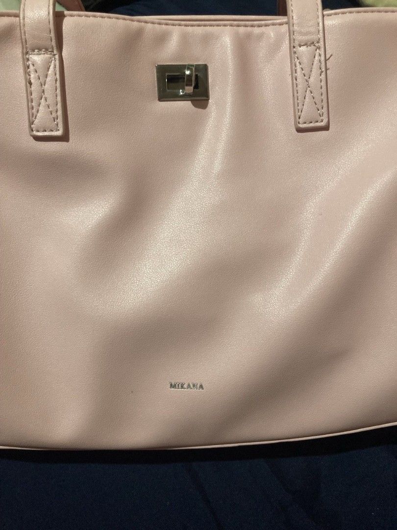 Mikana Pink Tote Bag (Category: Tote Bags) located in Bulacan. Submitted by geniestuffz (Listing ID 1434105177, Image 3). Description: - Mikana pink tote bag - Rectangular shape - Main compartment with zipper closure - Additional inner pocket - Silver-tone clasp and hardware - Made of smooth, faux leather material - Minor wear on corners note: Issue is nasa last pic. no to maselan po. I only used this for a month. bought for ₱900. kayo nalang po 