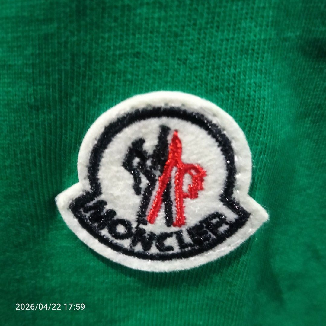 Moncler mens T-shirt (Category: Tshirts & Polo Shirts ) located in Manila. Submitted by mk_ukay (Listing ID 1434057385, Image 3). Description: - Authentic Moncler men's t-shirt - Color: Forest Green - Features a logo-collar design - Iconic Moncler logo patch on the sleeve - Classic crew neck and short sleeves - Includes brand tag with care instructions.