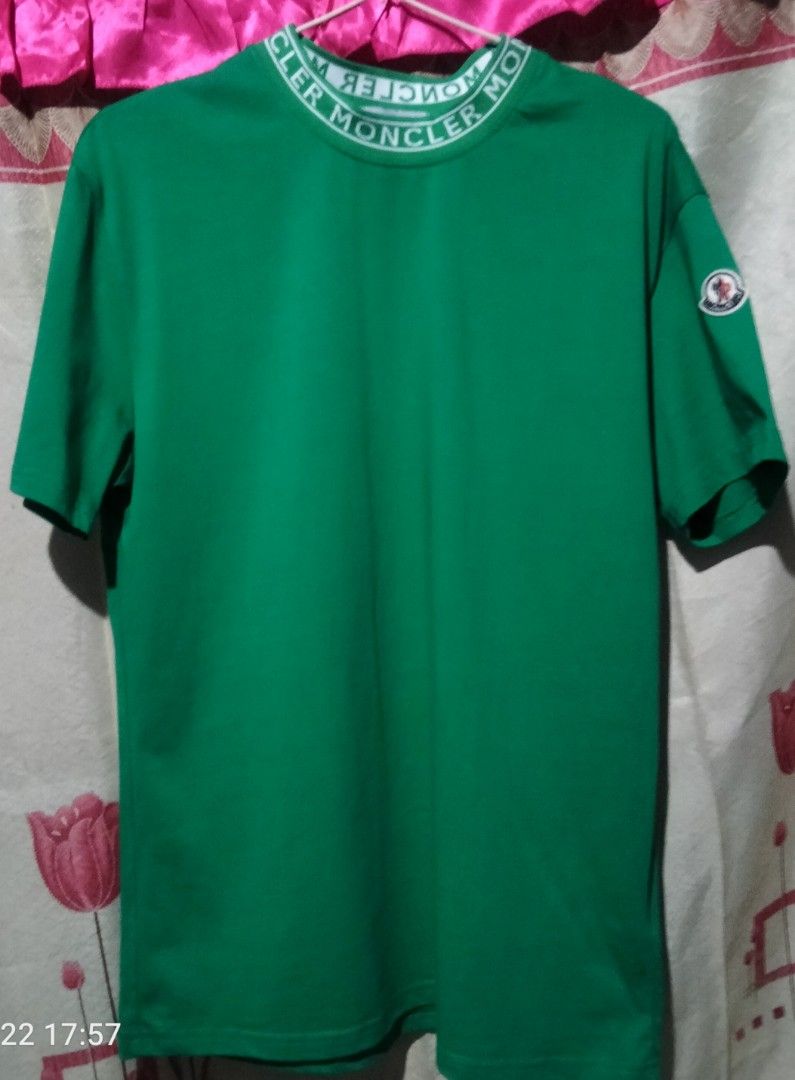 Moncler mens T-shirt (Category: Tshirts & Polo Shirts ) located in Manila. Submitted by mk_ukay (Listing ID 1434057385, Image 2). Description: - Authentic Moncler men's t-shirt - Color: Forest Green - Features a logo-collar design - Iconic Moncler logo patch on the sleeve - Classic crew neck and short sleeves - Includes brand tag with care instructions.