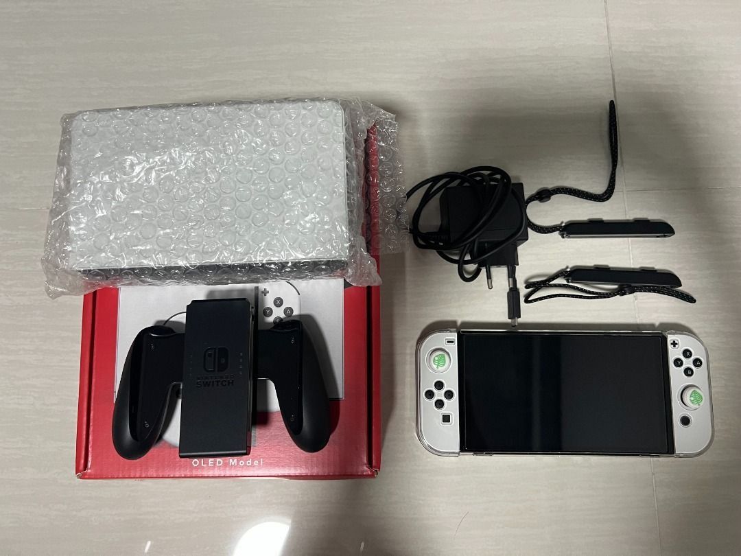Nintendo Switch OLED Model - White (Category: Nintendo) located in Singapore. Submitted by dnias (Listing ID 1434135607, Image 3). Description: Including everything that comes in the box. Screen has a screen protector on since day 1. Also throwing in a plastic cover for the switch and also a hard carrier cover. Meet up at my place only..