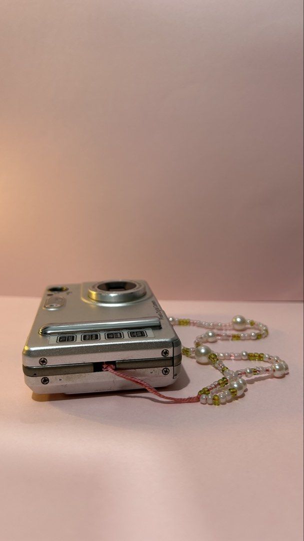 Pixels Digital Camera (Category: Cameras) located in Makati City. Submitted by belle.depop (Listing ID 1434015937, Image 3). Description: - Silver Pixels digital camera - 1.5" LTPS LCD screen - Features: TV, video, voice recording - 4x zoom - 8.0 MP - Includes decorative beaded strap - Lens: Digital Camera Lens f=2.8 f=5.6 80 cm-∞ 🍒 Issues: none. Scratches due to age/usage 🧳 Sample photos posted 🖼️ 🔋Powered by triple A batteries ✨Please manag