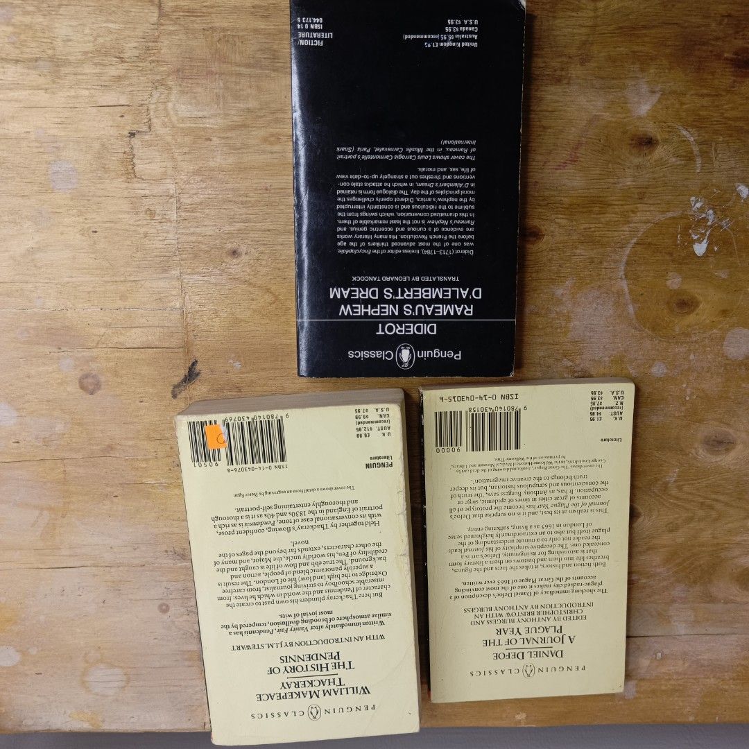 [Set] Penguin Classics Books (Category: Storybooks) located in Manila. Submitted by shelfenjoyment (Listing ID 1434127601, Image 2). Description: Sold: Diderot Set of three Penguin Classics books. Includes "A Journal of the Plague Year" by Daniel Defoe, "The History of Pendennis" by William Makepeace Thackeray, and "Rameau's Nephew/D'Alembert's Dream" by Diderot. The books are in paperback format. The spines and pages show some signs of age and w
