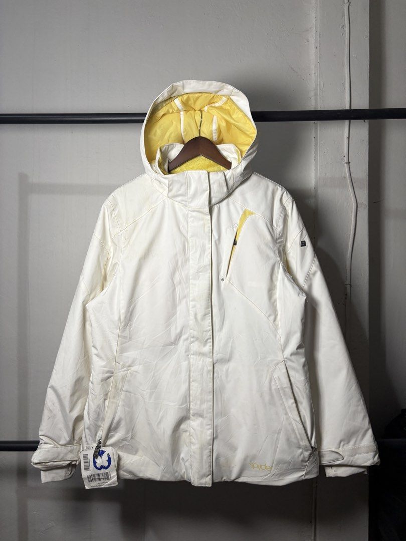 Spyder White and Yellow Ski Jacket (Category: Coats, Jackets and Outerwear) located in Manila. Submitted by angelll444 (Listing ID 1434053666, Image 1). Description: - Spyder ski jacket - Color: White with yellow accents - Size: L (22x28 dimes) - Features: - Hood - Multiple pockets - Thinsulate insulation - Interior: Yellow - Made in Vietnam - Spyder logo on front and back - Includes attached tag.