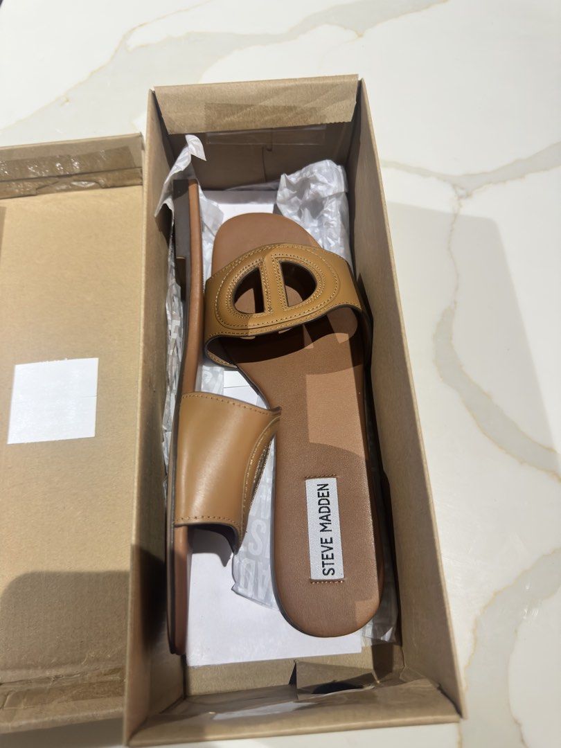 Steve Madden Kylah Tan Leather Sandals (Category: Flats & Sandals) located in San Fernando. Submitted by little_mavzzz (Listing ID 1434086430, Image 3). Description: Genuine Steve Madden Kylah sandals in tan leather. Features a stylish design with a distinctive 'O' detail on the straps. The sandals come with their original box. Size 8. Perfect for everyday wear or a casual outing. Comfortable and fashionable..