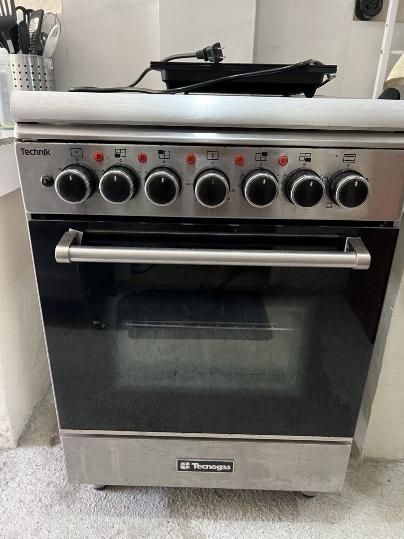 Technik Tecnogas Electric Oven with 4 Burners (Category: Ovens & Toasters) located in Binan City. Submitted by alreadyloved.p (Listing ID 1434025133, Image 1). Description: - Electric oven with 4 burners - Stainless steel exterior - Glass oven door - Includes oven racks and baking tray - Front panel oven controls - Circular electric burners - Stainless steel door handle Issue: oven light not working https://www.tecnogas.com.ph/tfe6004frss.html.