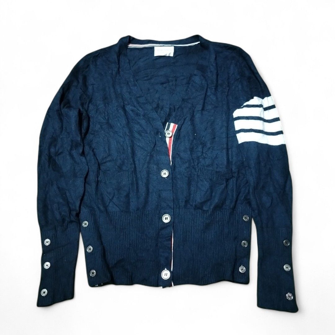 Thom Browne Navy Cardigan with Stripes (Category: Luxury Apparel) located in Cavite. Submitted by koyawell.ph (Listing ID 1434160641, Image 1). Description: - Thom Browne navy cardigan - Size 2 - 19 x 23 dimensions - excellent condition - Features: - White stripes on left sleeve - Button cuff details - V-neck - Red, white, and blue stripe detail on inside placket - Made in Italy.