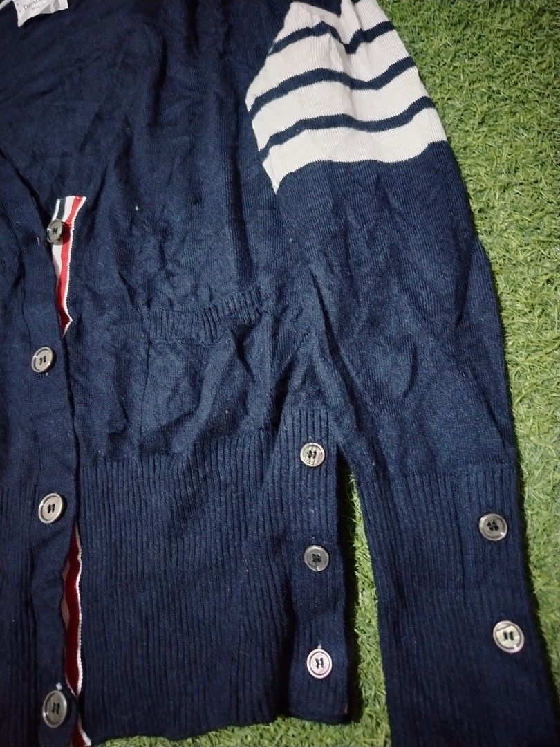 Thom Browne Navy Cardigan with Stripes (Category: Luxury Apparel) located in Cavite. Submitted by koyawell.ph (Listing ID 1434160641, Image 2). Description: - Thom Browne navy cardigan - Size 2 - 19 x 23 dimensions - excellent condition - Features: - White stripes on left sleeve - Button cuff details - V-neck - Red, white, and blue stripe detail on inside placket - Made in Italy.