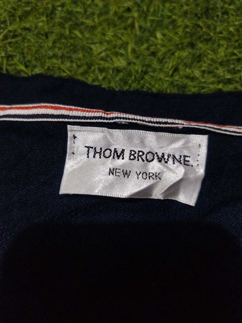 Thom Browne Navy Cardigan with Stripes (Category: Luxury Apparel) located in Cavite. Submitted by koyawell.ph (Listing ID 1434160641, Image 3). Description: - Thom Browne navy cardigan - Size 2 - 19 x 23 dimensions - excellent condition - Features: - White stripes on left sleeve - Button cuff details - V-neck - Red, white, and blue stripe detail on inside placket - Made in Italy.