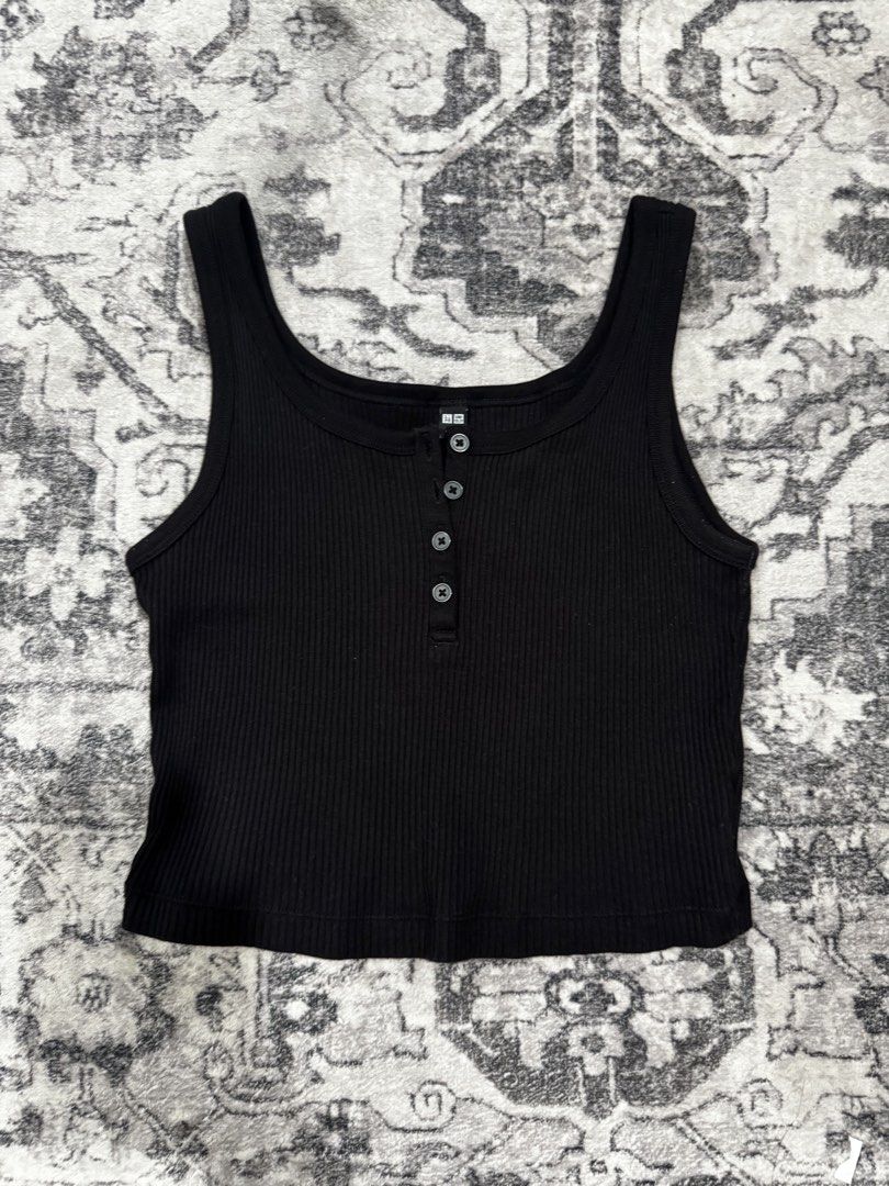 Uniqlo Black Ribbed Tank (Category: Sleeveless) located in Dumaguete. Submitted by whimsyqueen03 (Listing ID 1434053130, Image 3). Description: •In good condition •Soft stretchy ribbed fabric •Henley-style button front detail •Easy layering essential or wear on its own •Flattering fitted silhouette •Perfect basic for casual, clean girl, or capsule wardrobe styling •Pairs effortlessly with denim, cargos, and skirts • Its originally a size Large bu