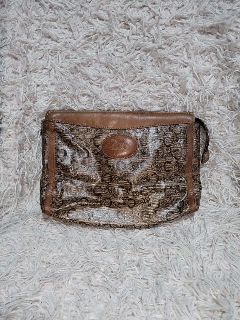 Vintage Celine Pouch Monogram (Category: Luxury Bags & Wallets) located in Pasig City. Submitted by loveforlux_2025 (Listing ID 1434043801, Image 1). Description: - Authentic Celine clutch bag - Brown monogram pattern - Leather trim - Zipper closure - Interior brown lining - Celine-Paris Made in Italy stamp - Small handle - Dimensions: Approximately 10 inches (length) x 6 inches (height).