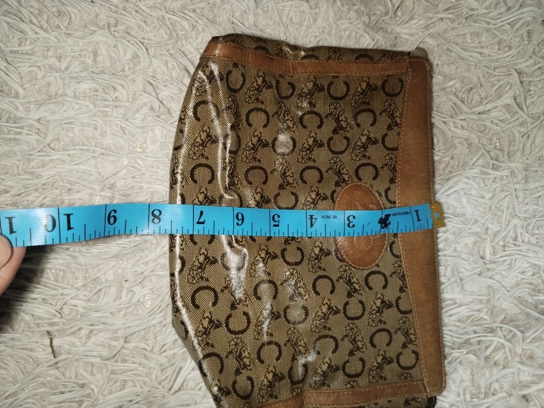 Vintage Celine Pouch Monogram (Category: Luxury Bags & Wallets) located in Pasig City. Submitted by loveforlux_2025 (Listing ID 1434043801, Image 3). Description: - Authentic Celine clutch bag - Brown monogram pattern - Leather trim - Zipper closure - Interior brown lining - Celine-Paris Made in Italy stamp - Small handle - Dimensions: Approximately 10 inches (length) x 6 inches (height).