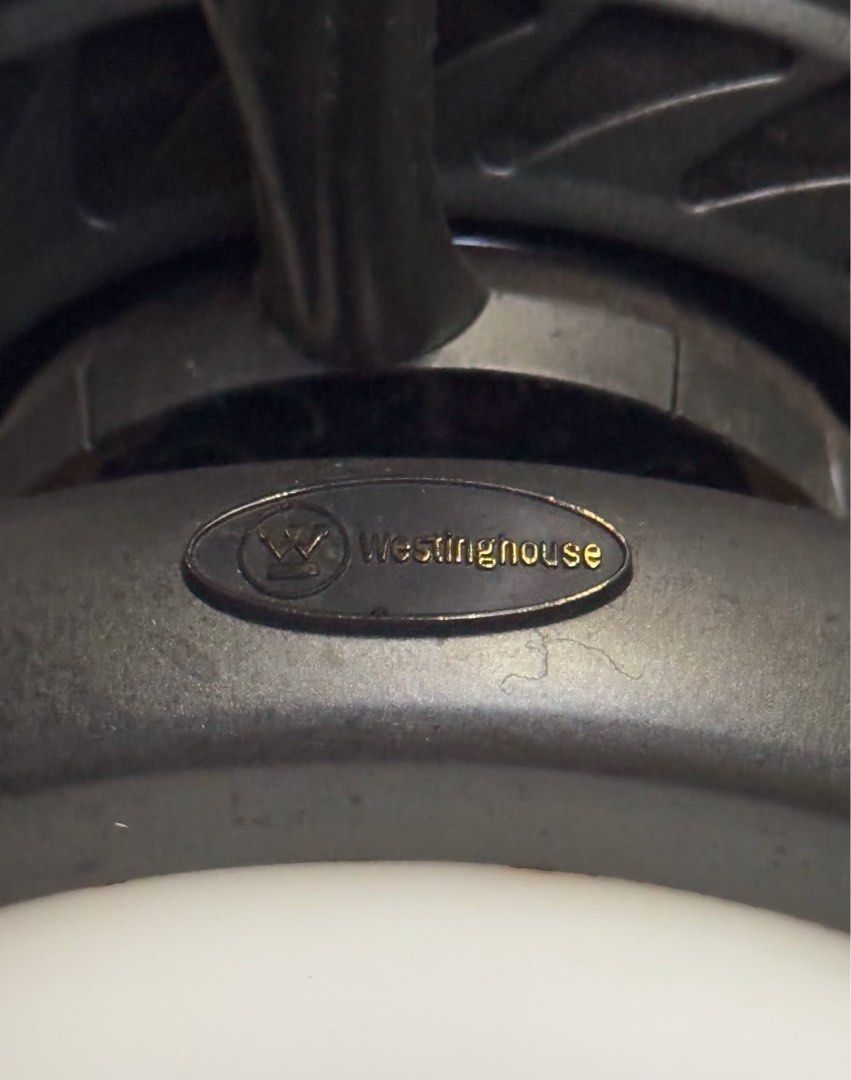 Vintage Westinghouse Ceiling Fan with Light (Category: Fans) located in Quezon City. Submitted by sortstudio.___ (Listing ID 1434011162, Image 2). Description: PLEASE READ: - Westinghouse ceiling fan with integrated light. - Features five dark brown blades. - Dark metal housing. - Frosted glass light cover. - Includes pull chains for fan speed and light control. - Mounted on a white ceiling. - Minor wear visible on blades. HONEST ISSUE: The light