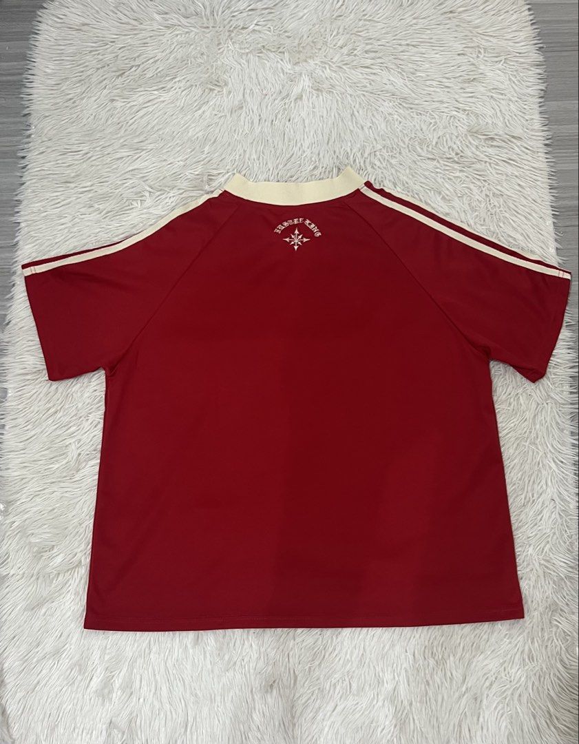 Winnersquad Jersey (Category: Activewear) located in San Pedro. Submitted by gavin_clothing8 (Listing ID 1434093372, Image 2). Description: - Red Winnersquad jersey - Cream-colored collar and sleeve stripes - Winnersquad logo and text on front - Unique design on the back - Lightweight material - Ideal for casual or sports use.
