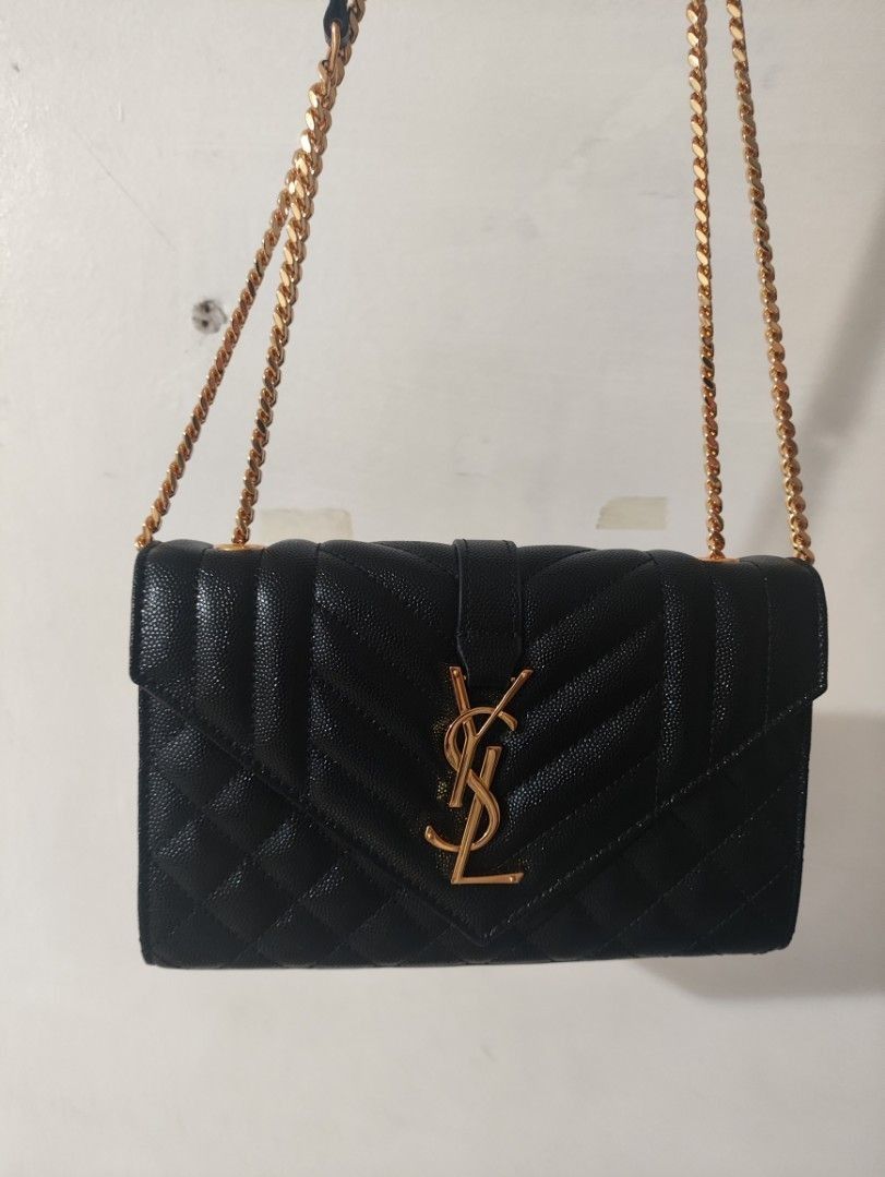 YSL Saint Laurent Wallet on Chain Black (Category: Luxury Bags & Wallets) located in Davao. Submitted by jenpolinar (Listing ID 1434132979, Image 1). Description: - Authentic YSL Wallet on Chain - Black, quilted design - Features gold-tone YSL logo - Includes chain strap - Flap closure - Leather lining with Saint Laurent Paris logo.