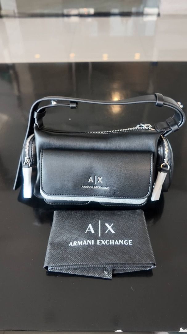 Armani AX Crossbody Bag (Category: Luxury Bags & Wallets) located in Taguig. Submitted by jess.jm (Listing ID 1434350053, Image 1). Description: Originally 12k. Negotiable and Open to offers. - Armani Exchange shoulder or kili bag - Color: Black - Main compartment and two front & side pockets - Adjustable strap - Lined interior with Armani Exchange logo - Includes dust bag and tags - Perfect for everyday or special events.
