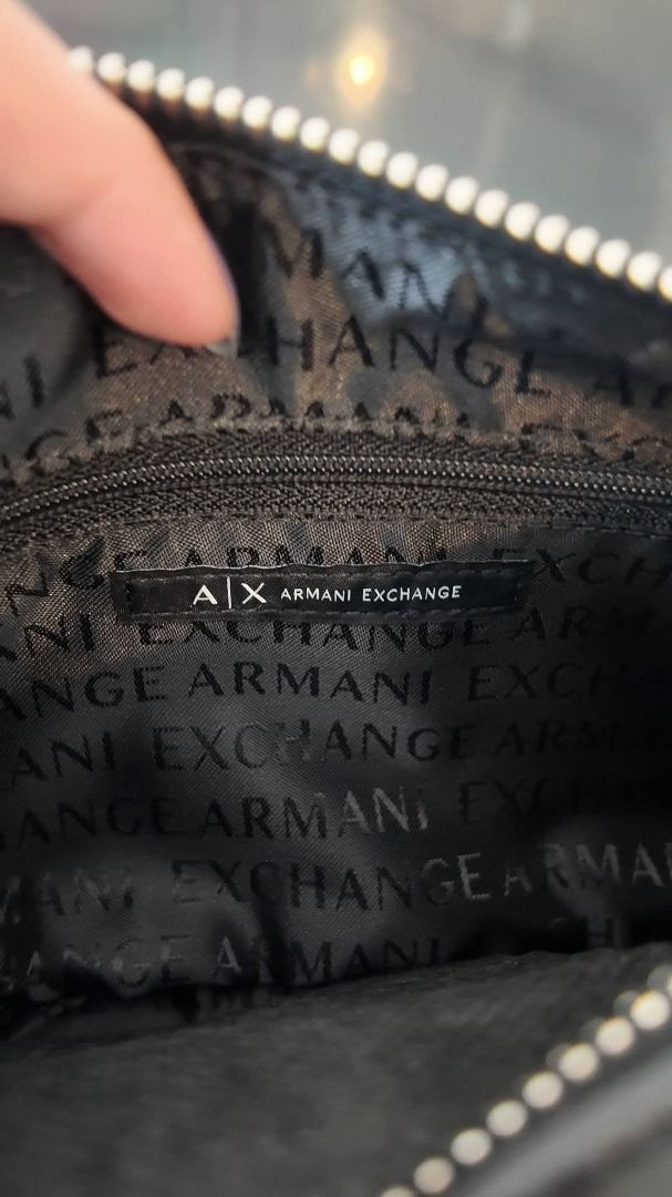 Armani AX Crossbody Bag (Category: Luxury Bags & Wallets) located in Taguig. Submitted by jess.jm (Listing ID 1434350053, Image 3). Description: Originally 12k. Negotiable and Open to offers. - Armani Exchange shoulder or kili bag - Color: Black - Main compartment and two front & side pockets - Adjustable strap - Lined interior with Armani Exchange logo - Includes dust bag and tags - Perfect for everyday or special events.