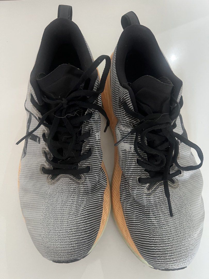 Asics Superblast Running Shoes - US 9.5 (Category: Sneakers) located in Singapore. Submitted by luckyfish_888 (Listing ID 1434232883, Image 2). Description: - Asics Metaspeed Sky running shoes - Color: Grey and orange - Size: US 9.5 - Visible wear on soles.