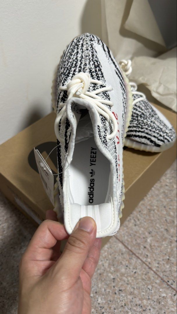 Authentic Adidas Yeezy Boost 350 V2 Zebra - US 9 (Category: Sneakers) located in Singapore. Submitted by glowing.skin (Listing ID 1434322917, Image 2). Description: - Adidas Yeezy Boost 350 V2 Zebra - Size: US 9 - Condition: Brand new, never worn - Includes original box, tags, and receipt - Perfect condition - Ready to ship.